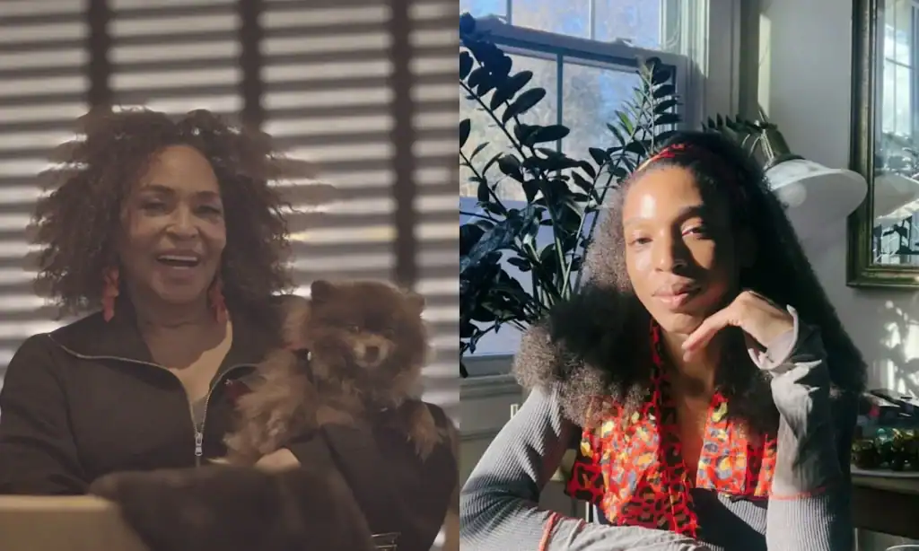 Andrea Horne, a smiling Black trans woman with light brown, chin-length curly hair framing her face, sits in the lobby of a hotel. She is holding her small and fluffy brown Pomeranian in front of a window, where the sun is shining through the slats of open Venetian blinds. And Sultana Isham, a young Black trans woman in a grey long-sleeved shirt, sits at a dining room table with one hand on her chin. There is an empty plate with silverware in front of her, a sprawling house plant behind her, and her shoulder-length curly brown hair is pushed back with a red patterned scarf.